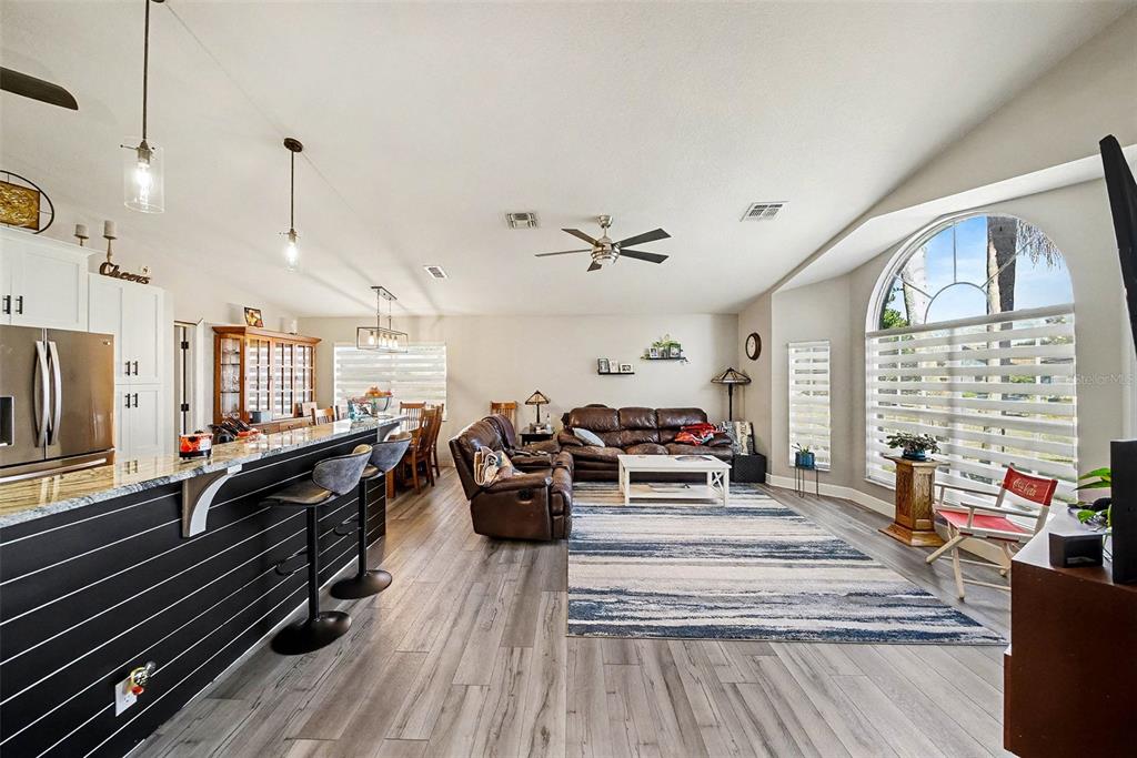 13749 Meade Court Hudson, FL 34667 - Photo 8 of 33 a living room with furniture fireplace and a large window