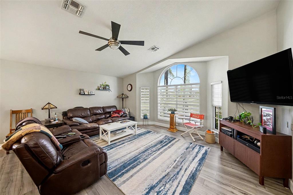 13749 Meade Court Hudson, FL 34667 - Photo 10 of 33 a living room with furniture and a flat screen tv