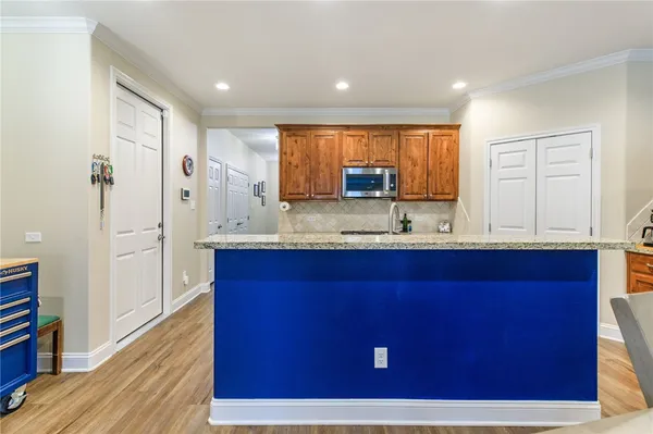 a kitchen with a refrigerator sink and cabinets