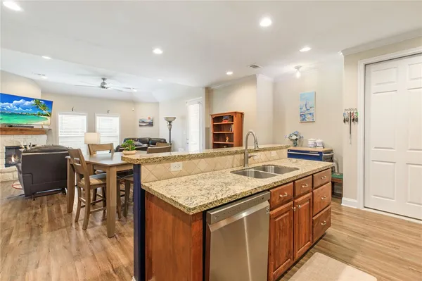 a kitchen with stainless steel appliances granite countertop a kitchen island a stove and a sink