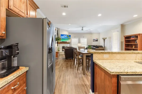 a kitchen with stainless steel appliances granite countertop sink stove top oven and cabinets