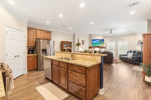 a kitchen with stainless steel appliances granite countertop a sink stove and refrigerator