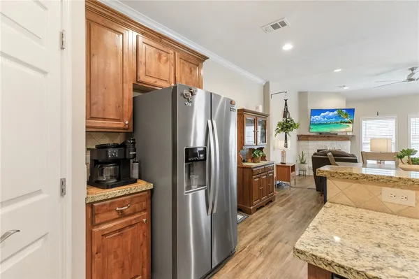 a kitchen with stainless steel appliances granite countertop a refrigerator and a stove top oven