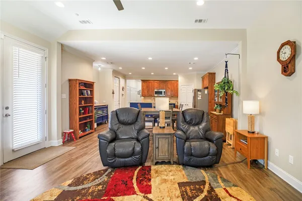a living room with furniture and a wooden floor
