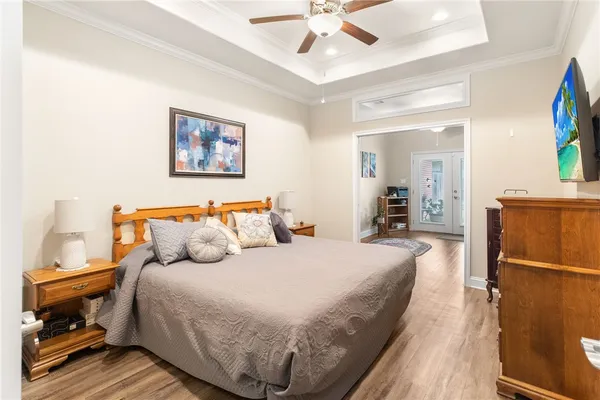 a bedroom with a bed and a chandelier