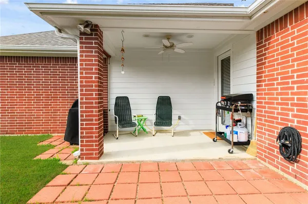 a building outdoor space with patio furniture and potted plants