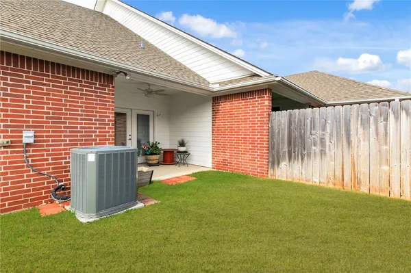 a backyard of a house with table and chairs