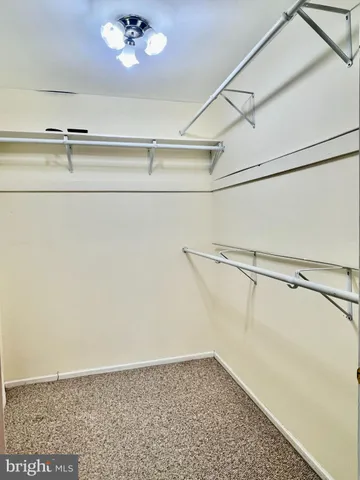 a view of a room with racks on the wall and shower