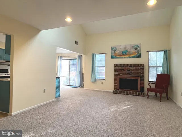 a view of a livingroom with furniture and a fireplace