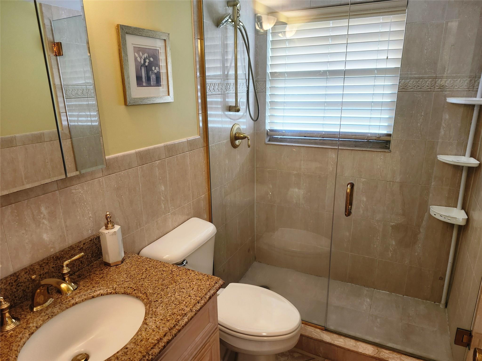 74 Preston Way Boca Raton, FL 33434 - Photo 15 of 28 a bathroom with a granite countertop toilet sink and shower