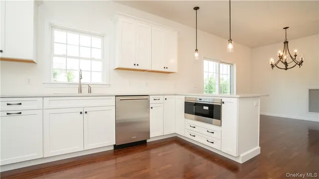 a kitchen with white cabinets and white appliances