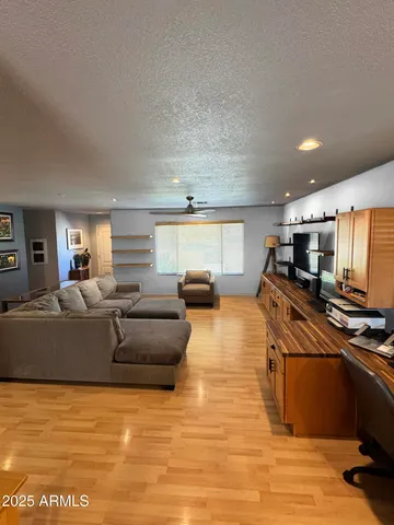 a living room with furniture stove and a flat screen tv