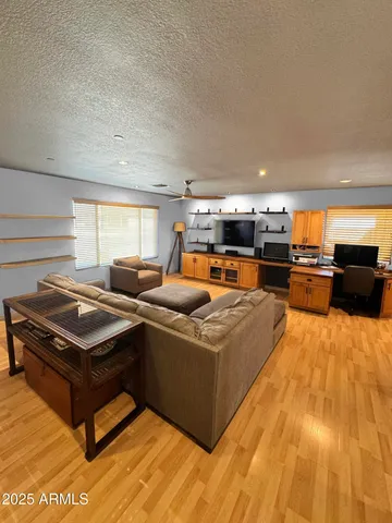 a kitchen with stainless steel appliances kitchen island granite countertop a refrigerator and a sink