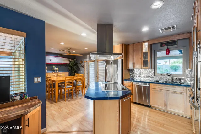 a kitchen with stainless steel appliances granite countertop a sink refrigerator and microwave