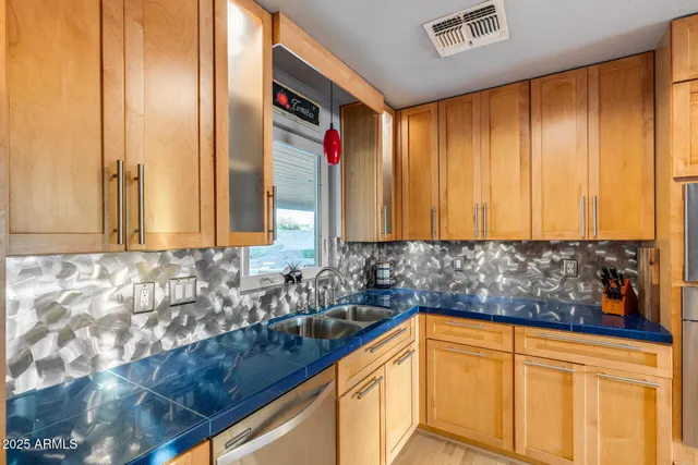 a dining table with stainless steel appliances kitchen island granite countertop a dining table and chairs with wooden floor