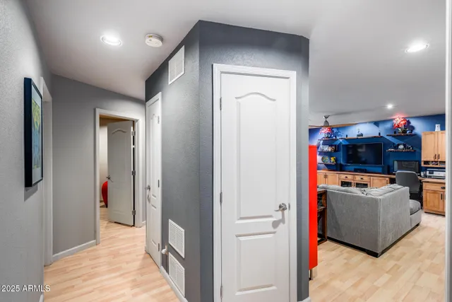 a bedroom with a large bed and a ceiling fan