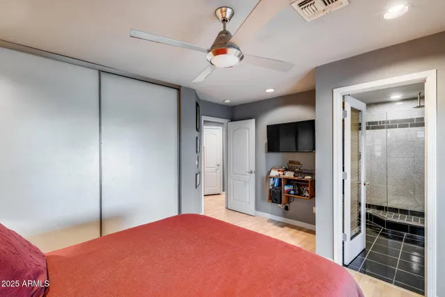 a bathroom with a granite countertop sink a mirror and shower