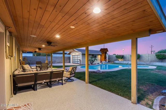 a view of a house with swimming pool yard fire pit and outdoor seating