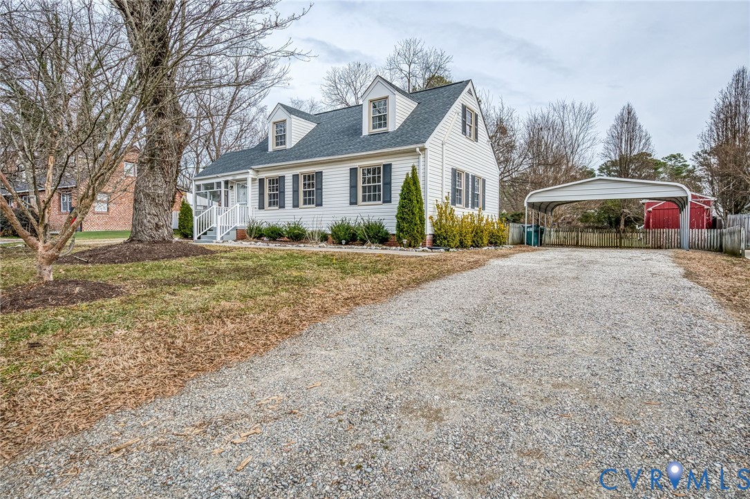 Cape Cod style home featuring gravel driveway, a 2