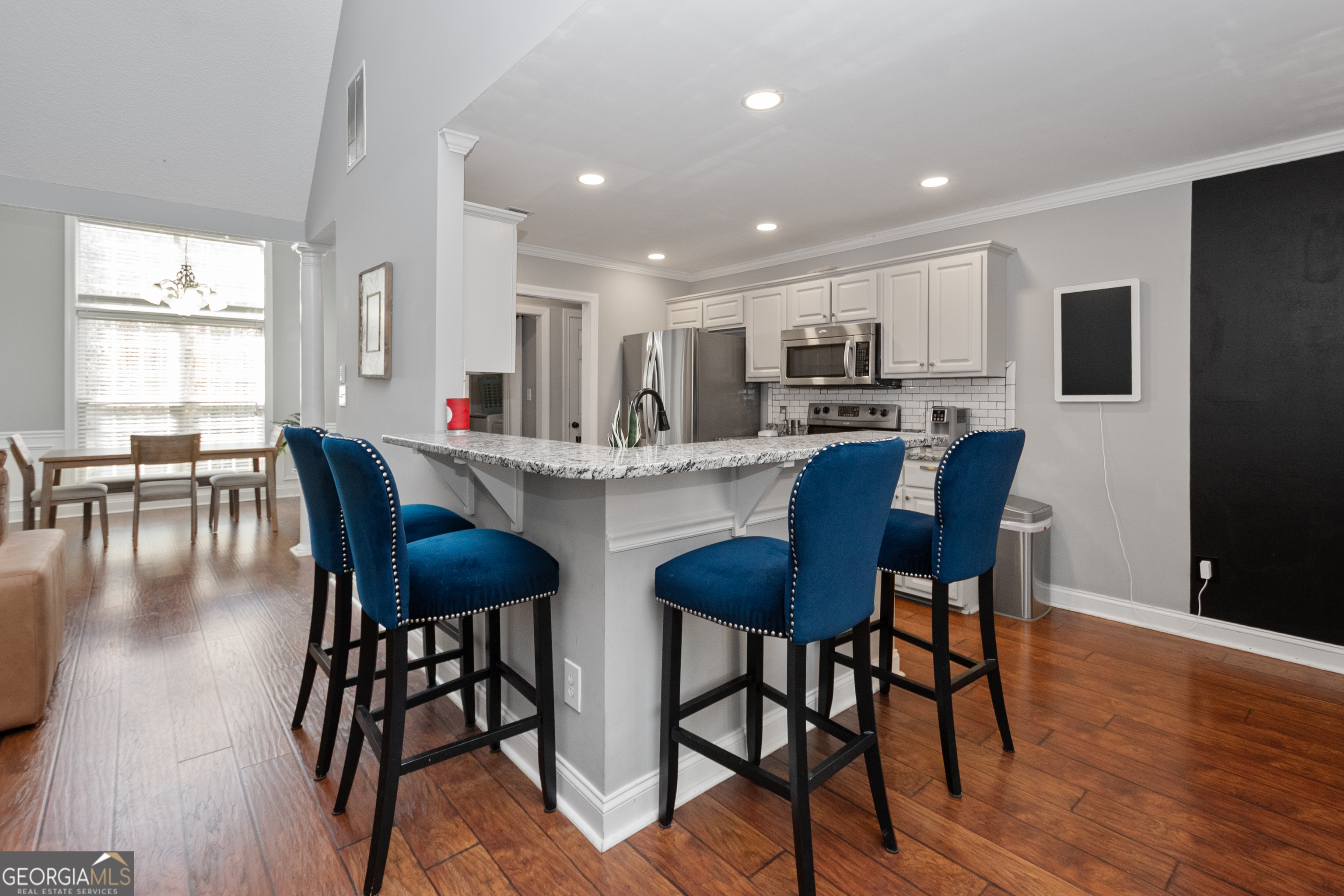 568 Martin Mill Road Moreland, GA 30259 - Photo 12 of 70 a dining area with stainless steel appliances kitchen island granite countertop a dining table chairs and granite counter tops