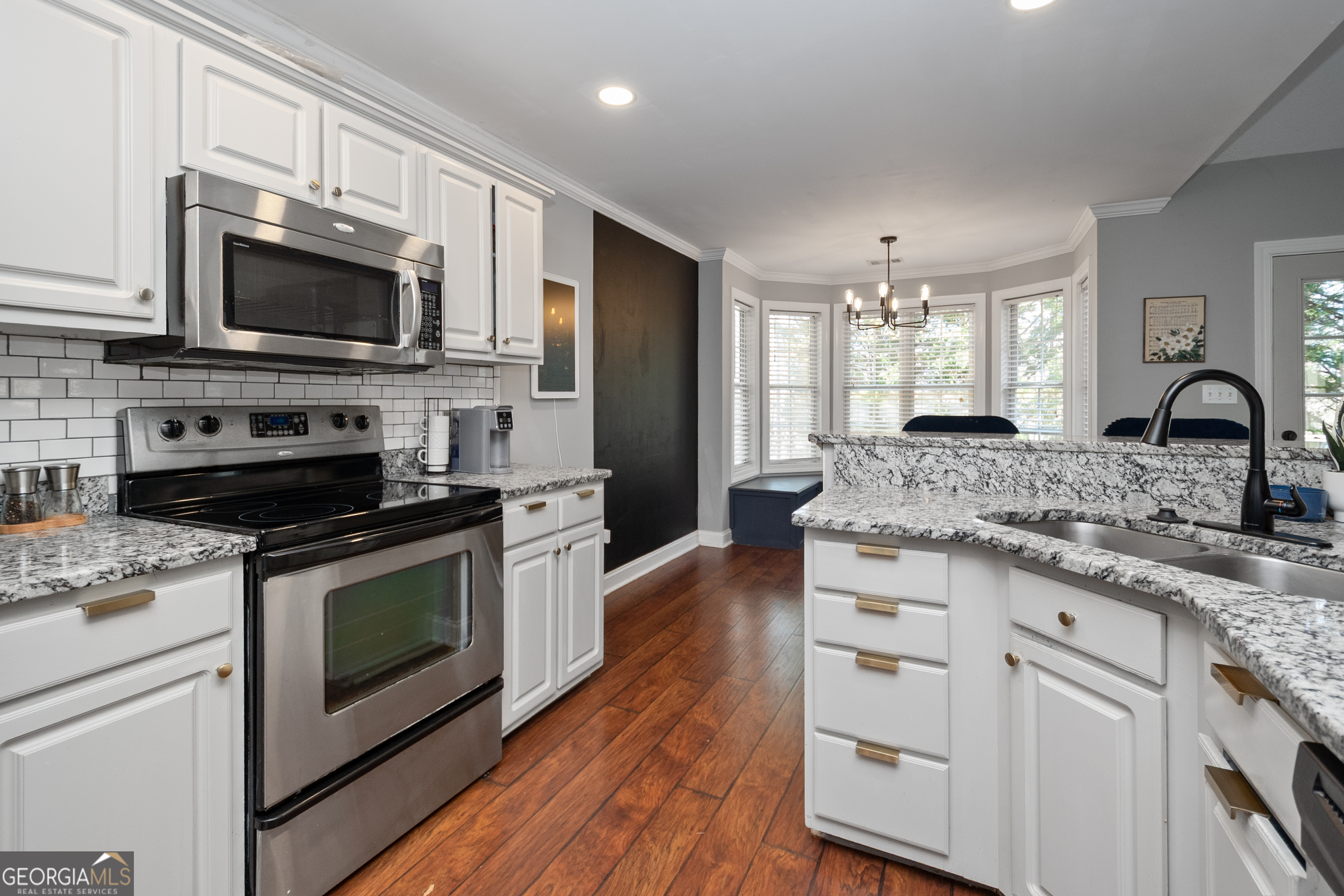 568 Martin Mill Road Moreland, GA 30259 - Photo 17 of 70 a kitchen with stainless steel appliances granite countertop a stove a sink and a microwave