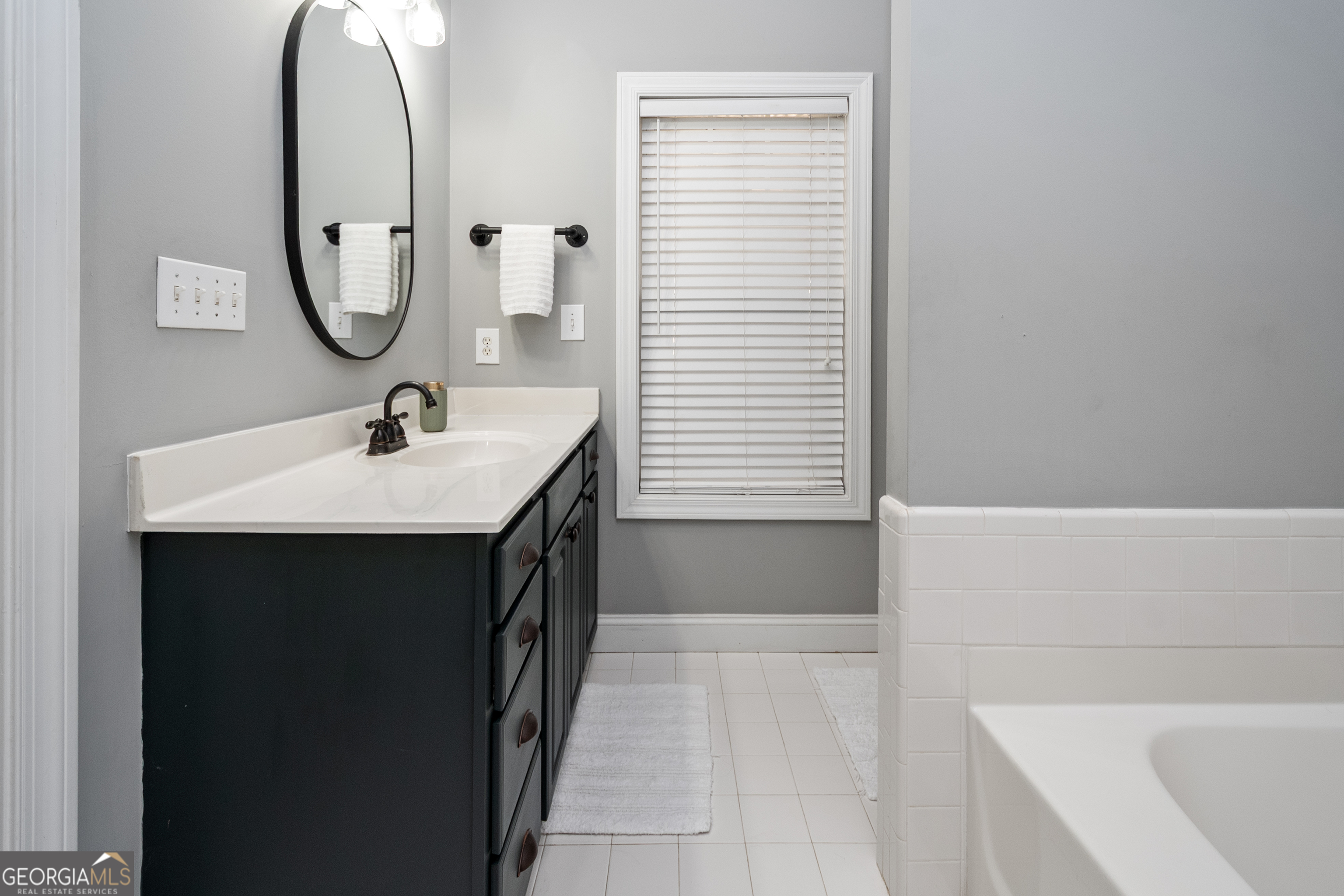 568 Martin Mill Road Moreland, GA 30259 - Photo 27 of 70 a en suite bathroom with a sink and a mirror