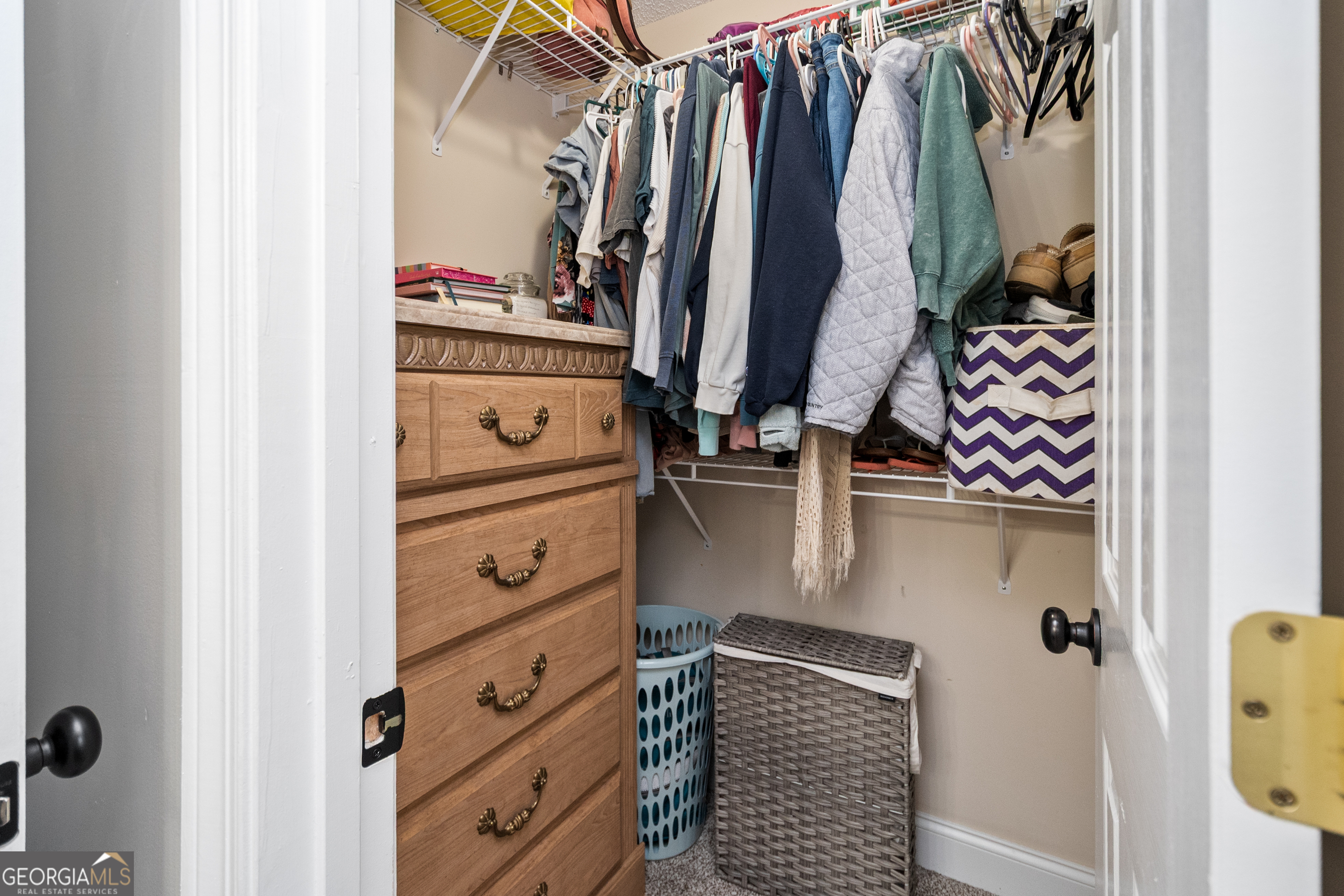568 Martin Mill Road Moreland, GA 30259 - Photo 31 of 70 a view of walk in closet with clothes