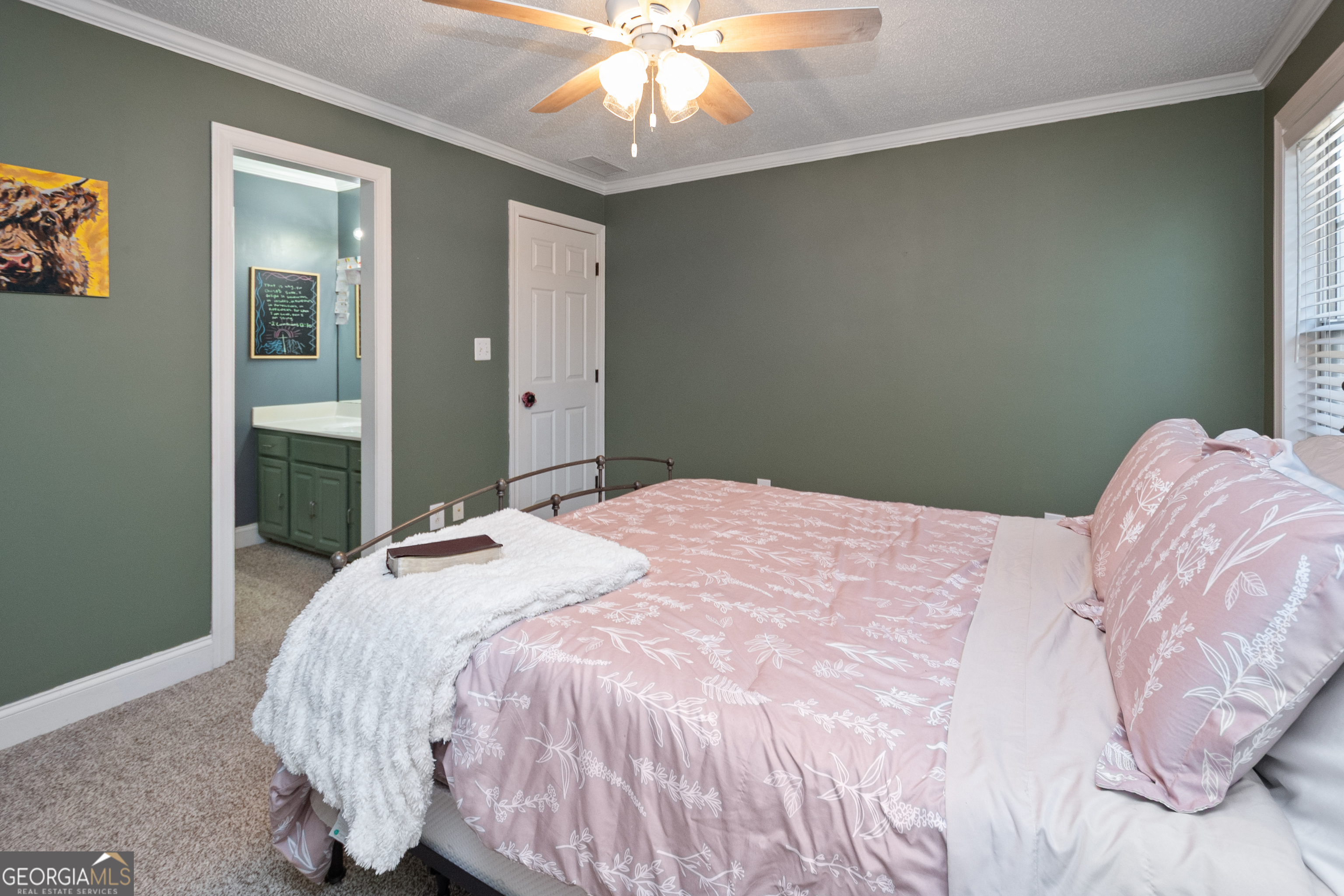 568 Martin Mill Road Moreland, GA 30259 - Photo 33 of 70 a bedroom with a bed and a chandelier