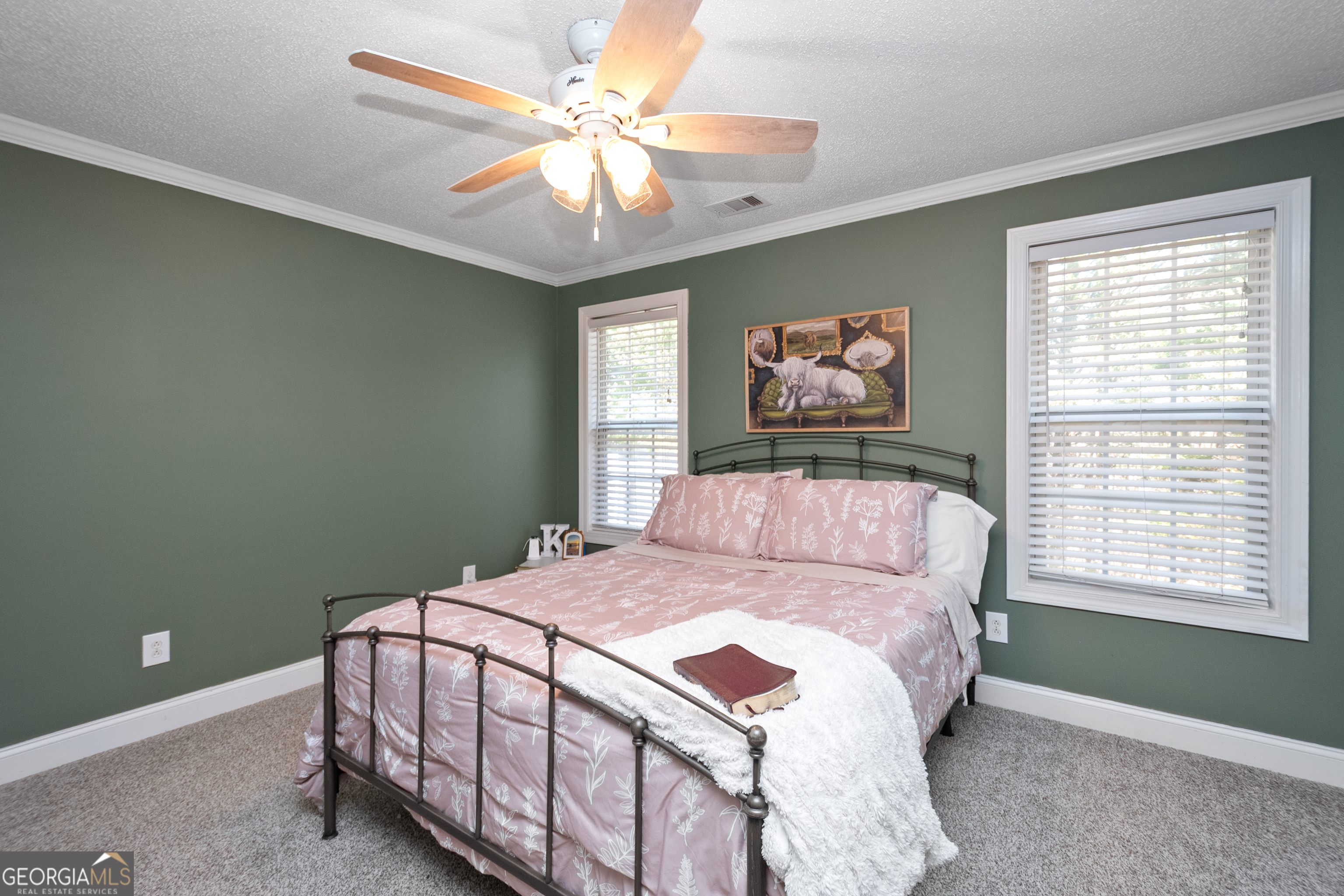 568 Martin Mill Road Moreland, GA 30259 - Photo 34 of 70 a bedroom with a large bed and a chandelier