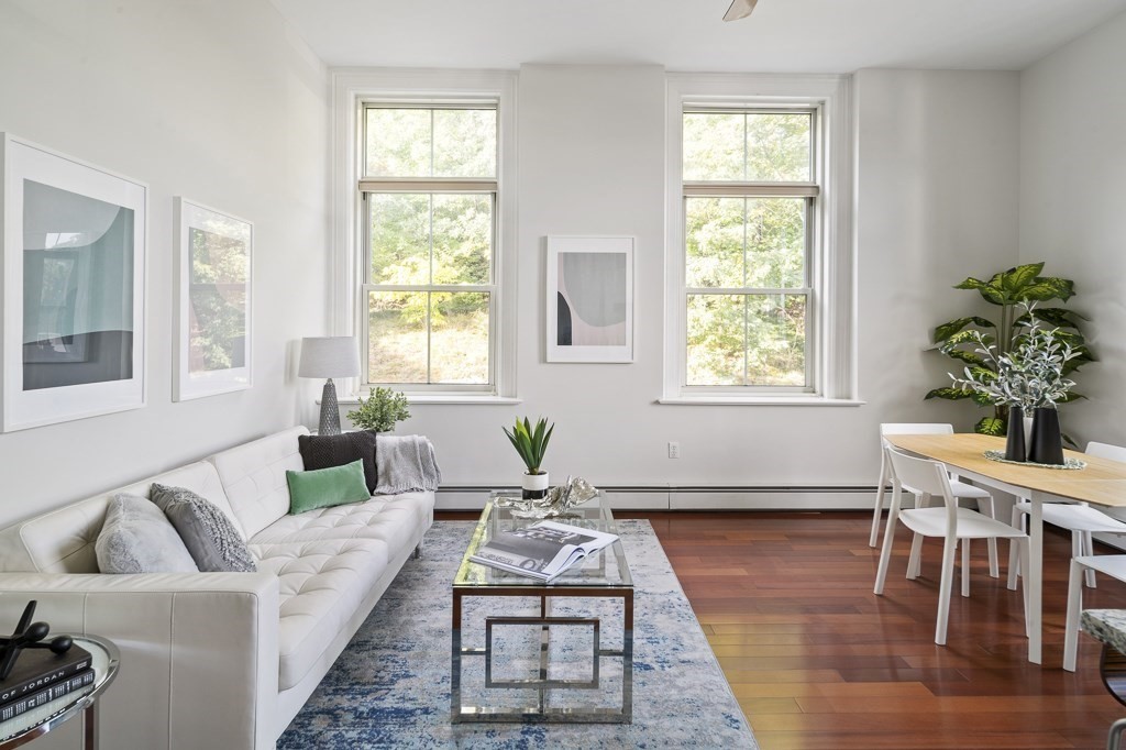 145 Glenwood Street, Unit 204 Malden, MA 02148 - Photo 1 of 13 a living room with furniture a wooden floor and a large window