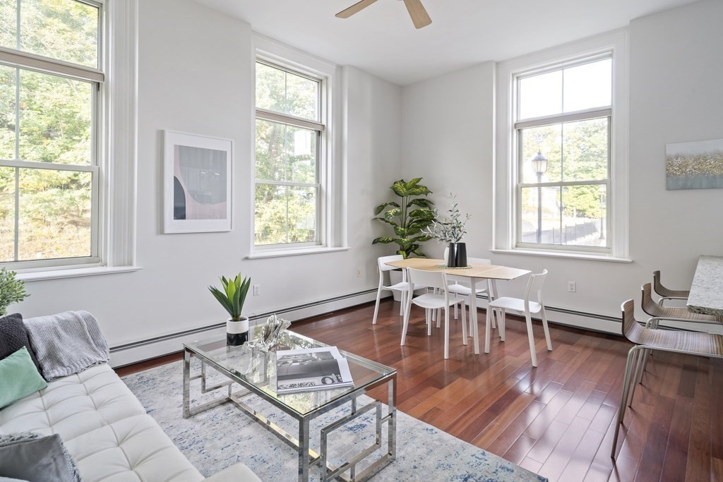 145 Glenwood Street, Unit 204 Malden, MA 02148 - Photo 2 of 13 a dining room with wooden floor a potted plant and windows