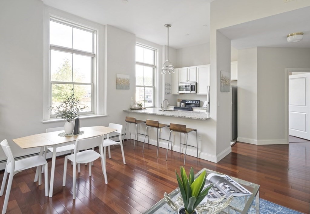 145 Glenwood Street, Unit 204 Malden, MA 02148 - Photo 5 of 13 a view of a dining room with furniture and wooden floor