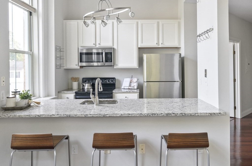 145 Glenwood Street, Unit 204 Malden, MA 02148 - Photo 6 of 13 a kitchen with stainless steel appliances granite countertop a sink refrigerator and cabinets