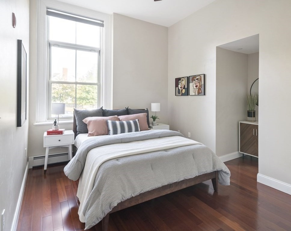 145 Glenwood Street, Unit 204 Malden, MA 02148 - Photo 8 of 13 a bedroom with a bed and wooden floor