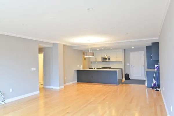 a large kitchen with a refrigerator and a stove