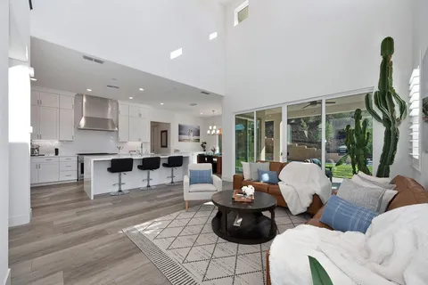 a kitchen with kitchen island a stove a sink and cabinets