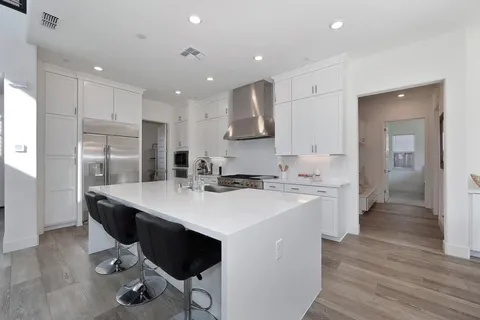a stove top oven sitting inside of a kitchen