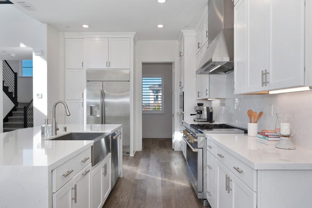 3063 Sherman Way El Dorado Hills, CA 95762 - Photo 15 of 75 a kitchen with stainless steel appliances granite countertop a sink stove and refrigerator