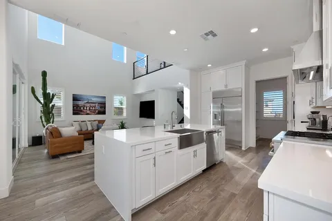 a dining room with furniture a chandelier and wooden floor