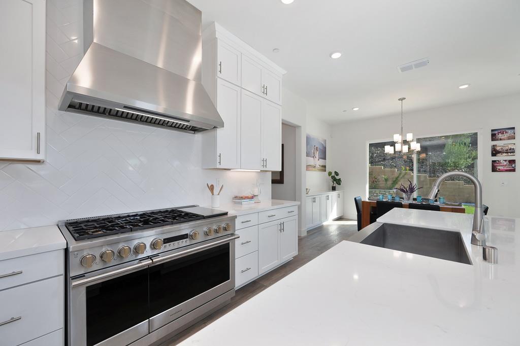 3063 Sherman Way El Dorado Hills, CA 95762 - Photo 19 of 75 a kitchen with white cabinets and appliances