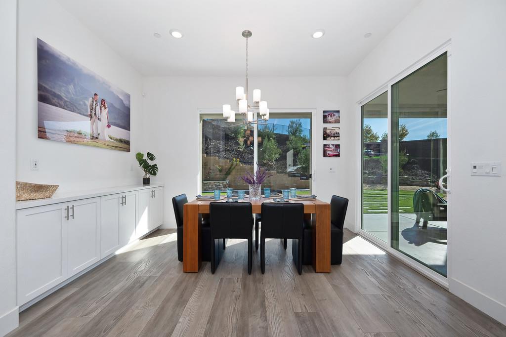 3063 Sherman Way El Dorado Hills, CA 95762 - Photo 23 of 75 a dining room with furniture a chandelier and wooden floor