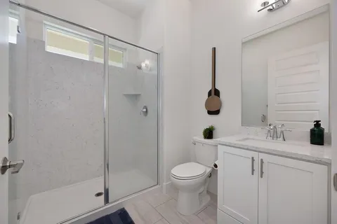 a bedroom with a bed a couch and a flat screen tv