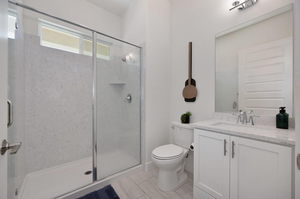3063 Sherman Way El Dorado Hills, CA 95762 - Photo 29 of 75 a bathroom with a granite countertop sink a toilet and shower