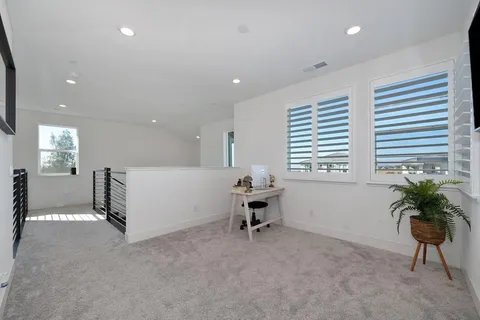 a spacious bathroom with a double vanity sink a mirror and toilet