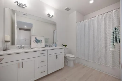 a spacious bedroom with a bed and a window