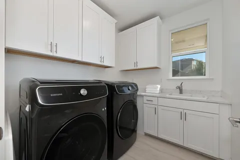 an aerial view of a house with a yard and lake view