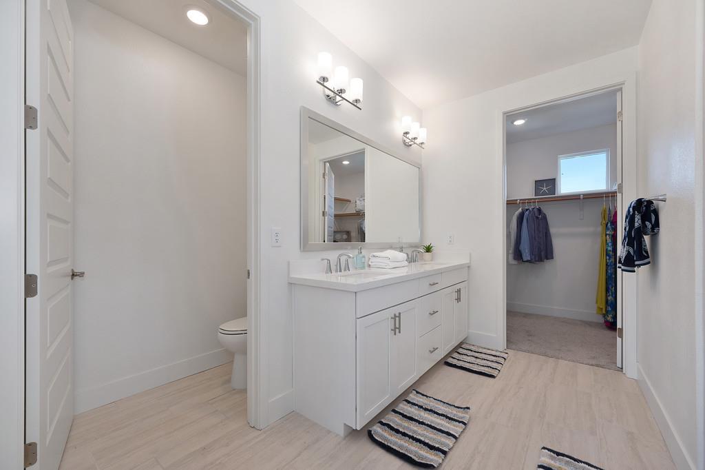 3063 Sherman Way El Dorado Hills, CA 95762 - Photo 41 of 75 a spacious bathroom with a double vanity sink a mirror and toilet