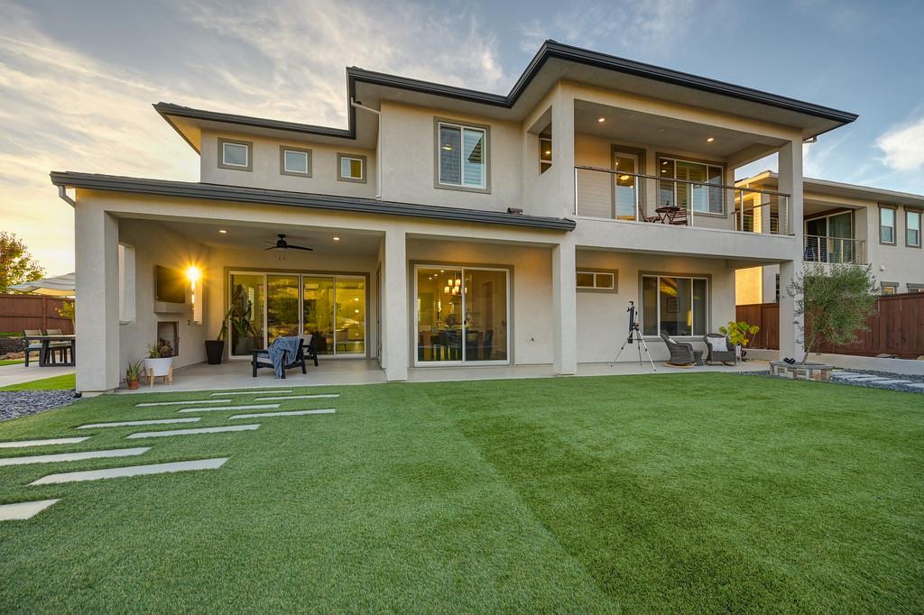 3063 Sherman Way El Dorado Hills, CA 95762 - Photo 56 of 75 a front view of a brick house with a big yard and potted plants