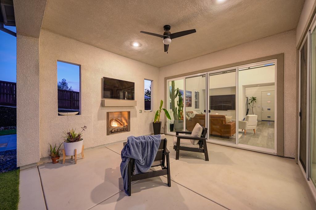 3063 Sherman Way El Dorado Hills, CA 95762 - Photo 70 of 75 a living room with furniture a fireplace and a flat screen tv