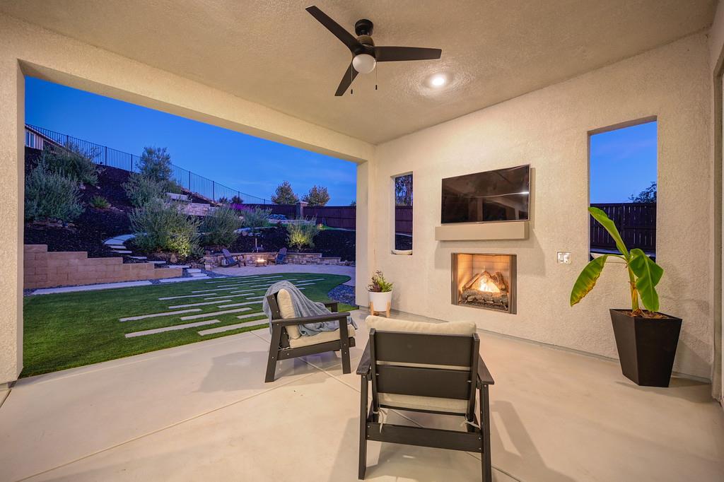 3063 Sherman Way El Dorado Hills, CA 95762 - Photo 72 of 75 a living room with furniture a fireplace and a flat screen tv